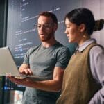 Two web developers working on a laptop to fix a lovable dev supabase error loop