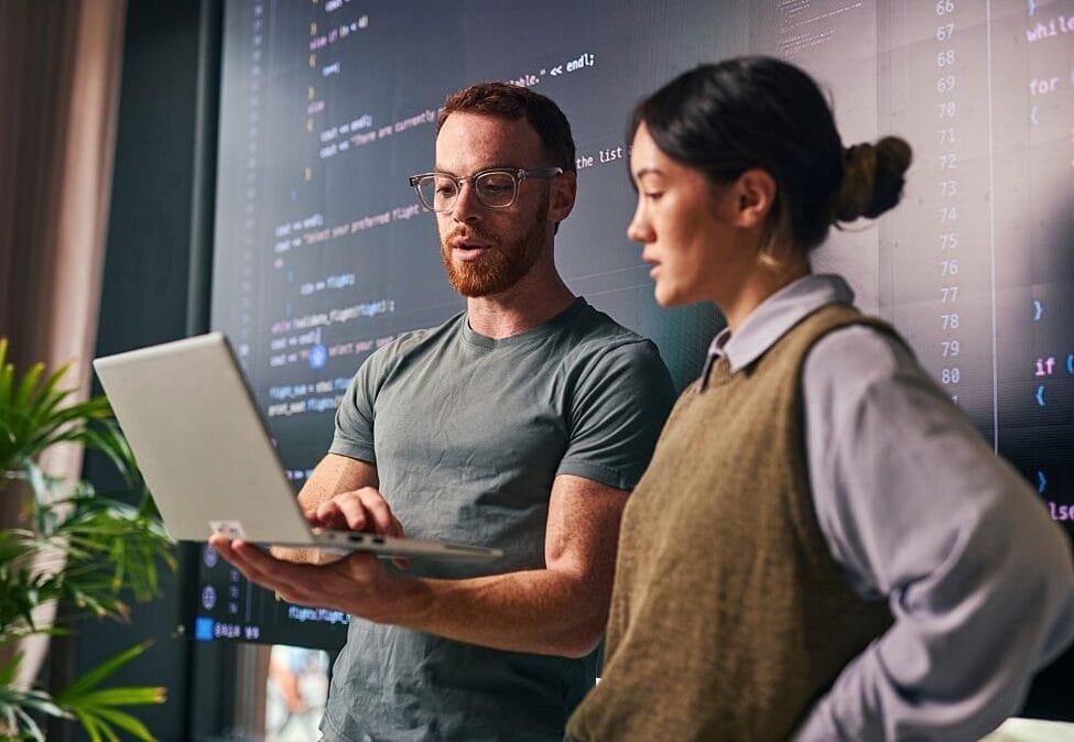 Two web developers working on a laptop to fix a lovable dev supabase error loop